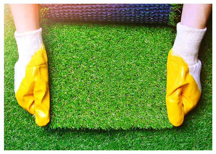 Hands Holding Artificial Turf